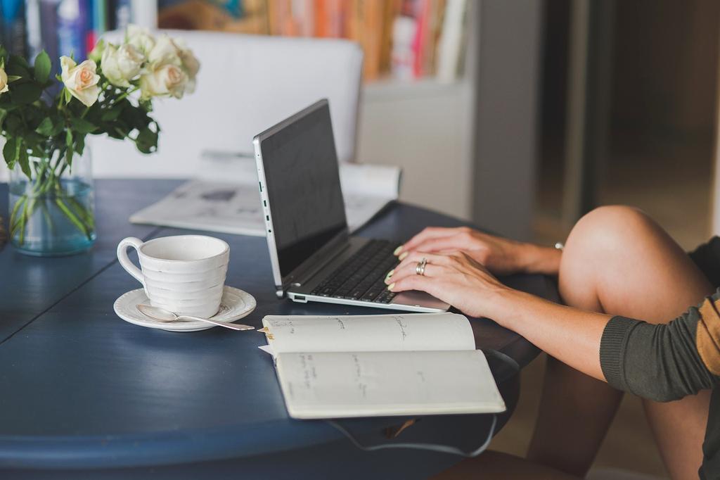 Laptop on a desk with a coffee cup