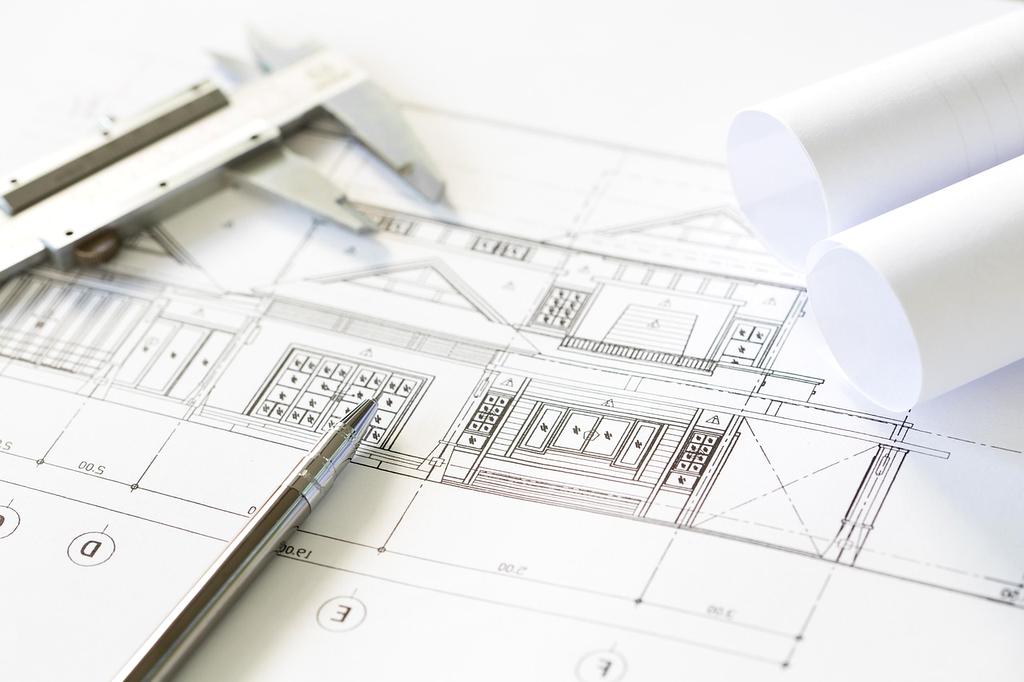 Architects working on blueprints at a desk